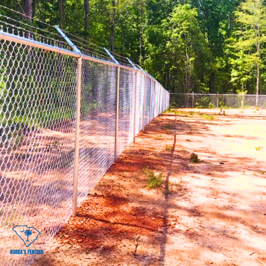 A Metal fence done by Bubba's Fencing with barbed wire at the top to keep intruders out